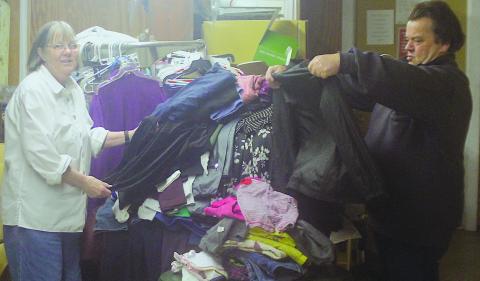 Volunteers Marie Johnson and Ray Such sort through donated items at the Highlands Emergency Council on Jan. 2.