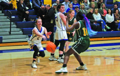 Highlands’ Hayley Borino (12) comes over a Kedra McCall (40) screen and  makes an entry pass to the post while Bessemer City’s Kiayzia Degree (10) defends during their NCHSAA 1-A State Playoff game on Tuesday night.