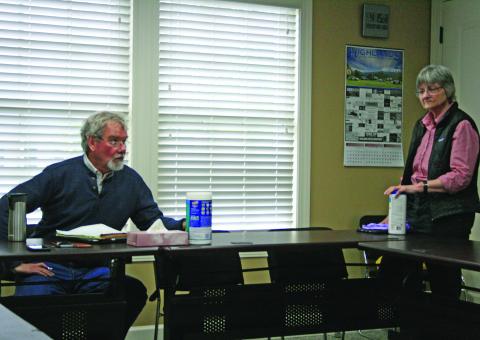 Mayor Patrick Taylor and commissioner Amy Patterson practice social distancing during their meeting on Monday.