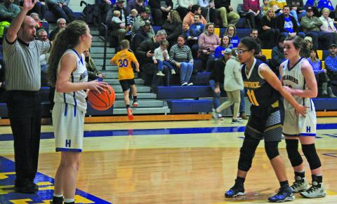 Highlands’ Jordan Carrier looks to inbound the ball to Kedra McCall as Langtree Charter’s Taylor Hall (11) defends during their NC High School Athetic Association 1-A state playoff game.