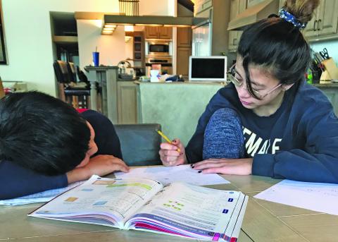 Micah and Annabelle Ham-Ye are taking part in e-learning from home and will be remotely attending school until June.