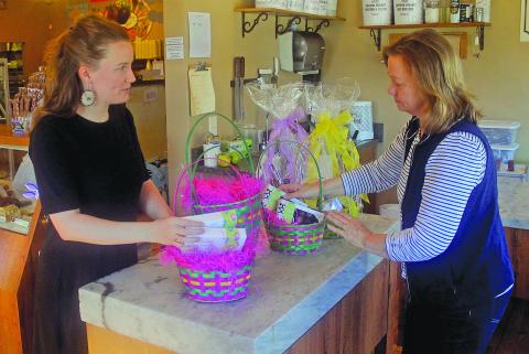 Kilwin's owner Ashley Clark and her mother Tallulah Adams pack baskets for their Easter basket sale this spring.