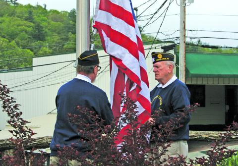 Members of Highlands American Legion Post 370 raise a new flag over the Veteran’s Plaza during the annual Memorial Day ceremony on Monday.