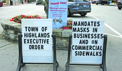Signs reminding visitors that masks are now mandatory on commercial sidewalks have been placed along Main Street and 4th Street.