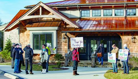 A group of Cashiers residents opposed to the proposed Cashiers Hillside development gathered with signs at the Village Green on Jan. 6 ahead of the Cashiers Area Community Planning Council’s meeting to review applications for legal standing in the upcoming hearing to determine the fate of the project.