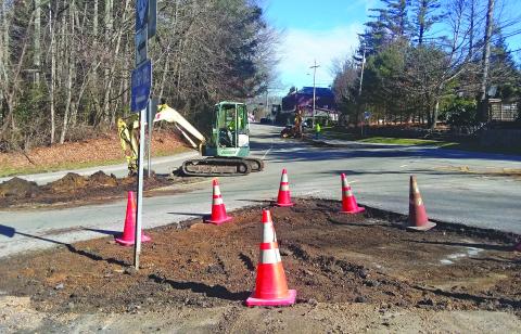 Crews work to remove cement dividers from the intersection of NC 28 and Satulah Road. The area is scheduled to be resurfaced as part of a larger project covering Main Street and US 64 in Highlands.