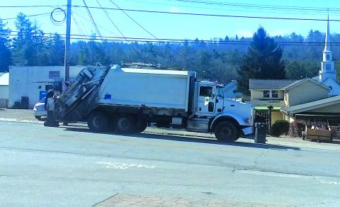 A Town of Highlands sanitation crew picks up commercial trash along Oak Street on Wednesday morning.