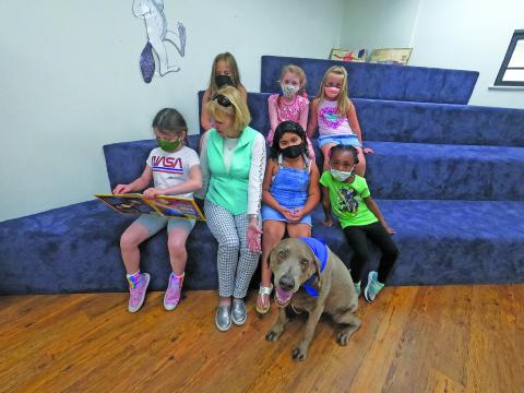 Photo by Christopher Smith/Staff   Ben the reading dog helps students gain confidence in their reading skills. 