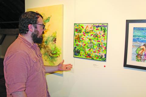 Photo by Christopher Smith/Staff  Zach Rogers explains the PLAY! exhibit. 