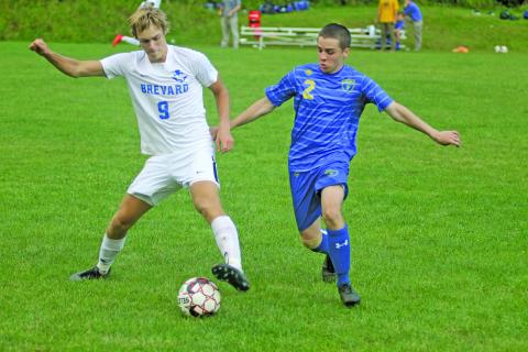 Photo by Christopher Smith/Staff Inman Ahrens fights for the ball against a Brevard forward in the Highlanders opening match. 