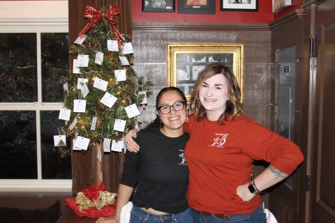 Photo by Christopher Smith/Staff Ugly Dog Pub manager Kellye Vos with worker Aileen Enriquez in front of the Christmas Tree. 