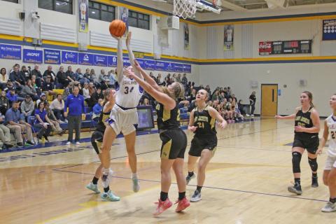 Photo by Christopher Lugo/Staff HHS junior Bella Wilson fights for a layup in the Lady Highlander’s win against Hayesville, Friday night. 