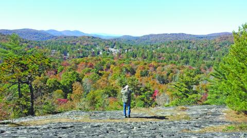 Photo by Pam Kolber/STaff Chet Kolber takes a picture at the edge of Sunset Rock, which is owned by the Highlands Cashiers Land Trust. 