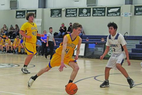 Photo by Michael O’Hearn/Crossroads Chronicle HHS senior J.D. Head dribbles against Summit on Tuesday. 