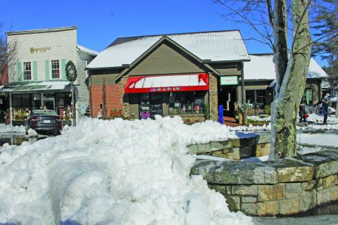 Photo by Christopher Lugo/Staff Snow piled on Main Street after town employees plowed the street.