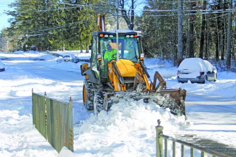 Road crews are still at work plowing snow out of the streets. Photo by Christopher Lugo/Staff