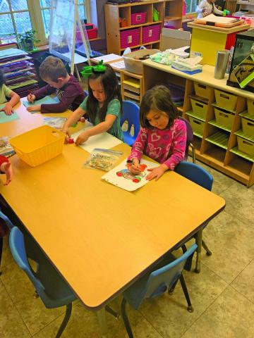 Photo by Christopher Lugo/Staff Students at Highlands Community Child Development Center colors a picture. 
