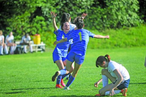 Photo by Christopher Lugo/Staff Senior Reese Schmitt congratulates sophomore Aislynn Luck after her goal against Queens Grant. 