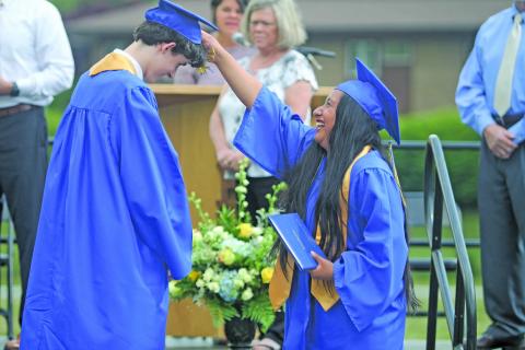 Photo by Christopher Lugo/Staff Highlands graduate Ruth Mendoza-Hernandez turns the tassel of fellow classmate, Liam Kennedy.
