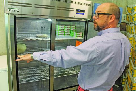 Photo by Christopher Lugo/Staff IFC executive director T.J. Smith showcased the lack of chicken in the Highlands Food Pantry freezer. 