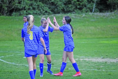 Photo by Christopher Lugo/Staff Highlands seniors Hayley Borino and Reese Schmitt high-five after a goal against Hayesville. 