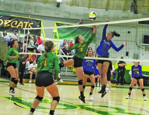 Highlands’ Caitlin Tingen (11) goes up for a kill as Blue Ridge defenders McKenzie Woods (6) and Isabella Moody (1) get into position during their match on Tuesday night.