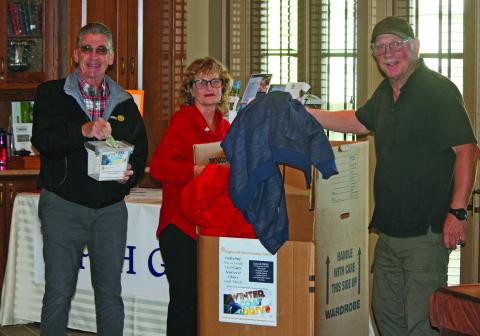Members of the Mountaintop Rotary Club of Highlands placed the first donated coats in a drop box at First Presbyterian Church on Friday, Oct. 28.