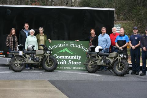 Photo by Ryan Hanchett/Staff Mountain Findings board members Jill Helmer, Steve Parnell, Steve Mehder, Delaine Mehder, John Warner, Amy Cooper and Beth Townes presented two new rescue motorcycles, safety equipment and a trailer to Todd Doster with Macon County EMS and members of Macon County Squad 4 fire and rescue. Not pictured are board members Lou Rosebrock and Dan Rupp.