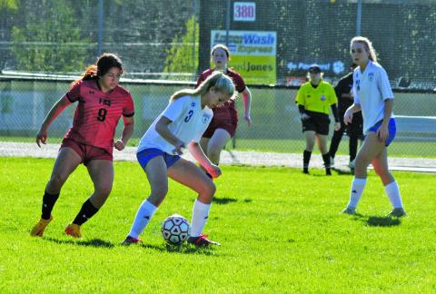 Highlands’ Addie Westendorf (3) controls the ball while being pressured by the Franklin defense during their game at Macon Middle School.