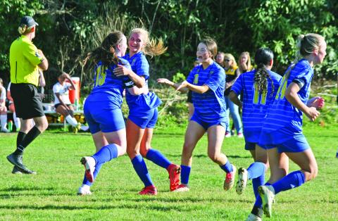Highlands’ Caroline Woods (15) and Addie Westendorf celebrate after they connected on a corner kick for Highlands third goal of the first half against Murphy on Tuesday night. Highlands went on to win the game 6-2.