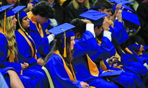 Highlands 2023 graduates put on their caps prior to receiving their diplomas during Saturday’s commencement ceremony.