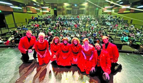 The cast of Home for the Holidays paused for a photo with area school students during a recent performance.