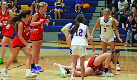 Highlands and West Oak players hit the deck to grab a loose ball during their game on Friday night. The Warriors seized a 45-34 victory.