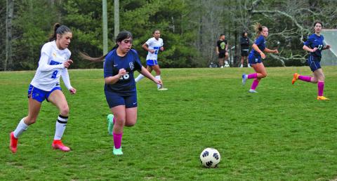 Highlands’ Aislynn Wyatt-Luck (9) chases down a Summit Charter midfielder during their season-opening soccer match on Tuesday night.