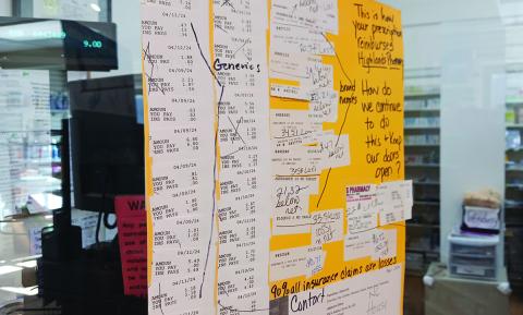 Sherry Sims hung up several receipts she’s gotten from insurance companies, which she said shows the poor reimbursement rates on prescriptions that might force her to close her business if she keeps losing money.