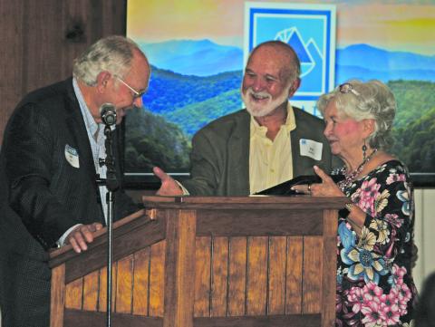 Stell Huie presents an award to Ray and Diane McPhail for their years of support to Pisgah Legal Services in Highlands and Cashiers during an organizational breakfast on Tuesday.