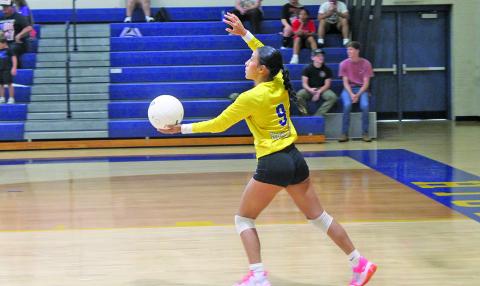 Highlands’ Karen Gomez delivers a serve during the Lady Highlanders opening match.