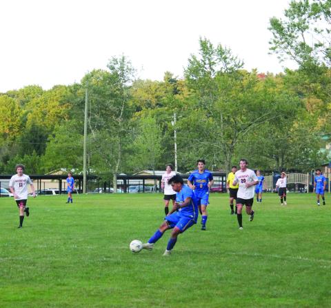 Highlanders junior Bryan Jarquin delivers a shot on goal at the home game Monday night, which found the back of the net and added to his team’s lead.