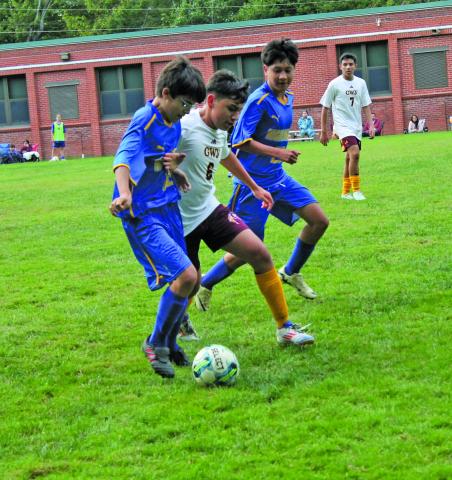 Highlanders sophomore Francisco Gooch (left) and junior Jesus Mendoza vie for the ball against a member of the Cherokee Braves during their match on Monday night.