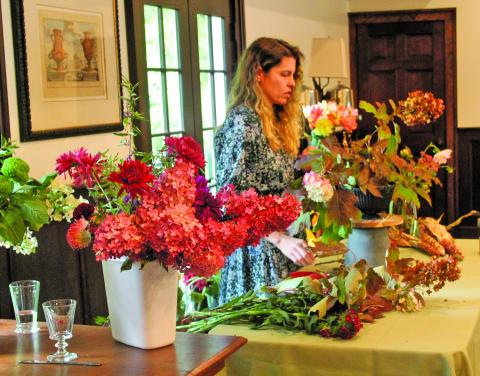 Christy Curcuru showed guests at “Snip, Sip, and Support” how to properly arrange fall flowers.
