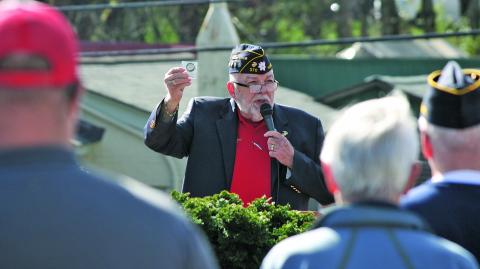 American Legion Post 370 chaplain Ed McCloskey shows off a newly minted coin commemorating the post’s 77th anniversary in Highlands.