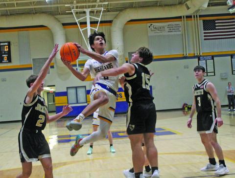 Highlands’ Gustaf McRae (0) drives between a pair of Hayesville defenders during their game on Tuesday night.
