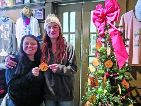 Ugly Dog Public House manager Kellye Wert (right) and server Charity Barnes at the restaurant, which is a site where people can donate gifts for the Angel Tree program.