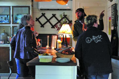 Highlands Chamber of Commerce Executive Director Kaye McHan (left) and a group of select invitees got the first look at the wine bar at the Outpost Inn.
