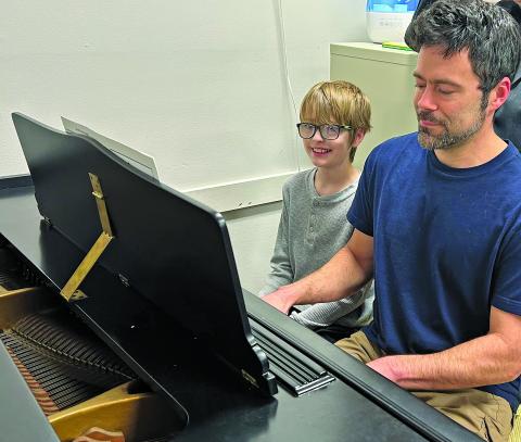 JCYC accompanist Bryan Heller gives chorus member Riley Breedlove a preview of a song he will sing when rehearsals begin in March.