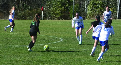 Blue Ridge forward Isabella Moody (12) looks for a passing lane as Highlands defender Olivia Corbin (22) closes the gap on Monday afternoon.