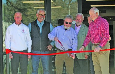 Photo by Ryan Hanchett/Staff Highlands ABC General Manager Kevin Vinson cuts a ribbon at the new store location on Oak Street. He was joined on Thursday by ABC board members Rick Trevathan, Jim Ward, Dave O’Harra, Andy Chmar and Steve Mehder.