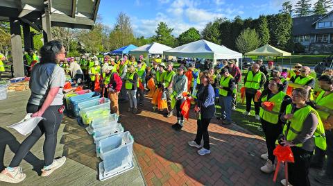 Volunteers gather in Kelsey-Hutchinson Founders Park for a safety briefing prior to the 2025 Plateau Pickup litter sweep on Saturday.