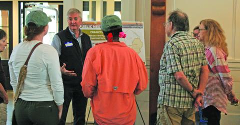Headwaters District Conservation Plan steering committee member David Feist, who represents the Friends of Lake Glenville, discusses the proposed plan and the methodology behind it with a group of citizens at The Village Green in Cashiers on Wednesday.