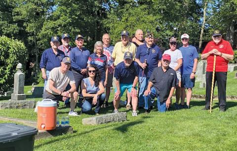 Legionnaires and volunteers gathered to place flags at veterans’ grave sites at the Highlands Cemetery.